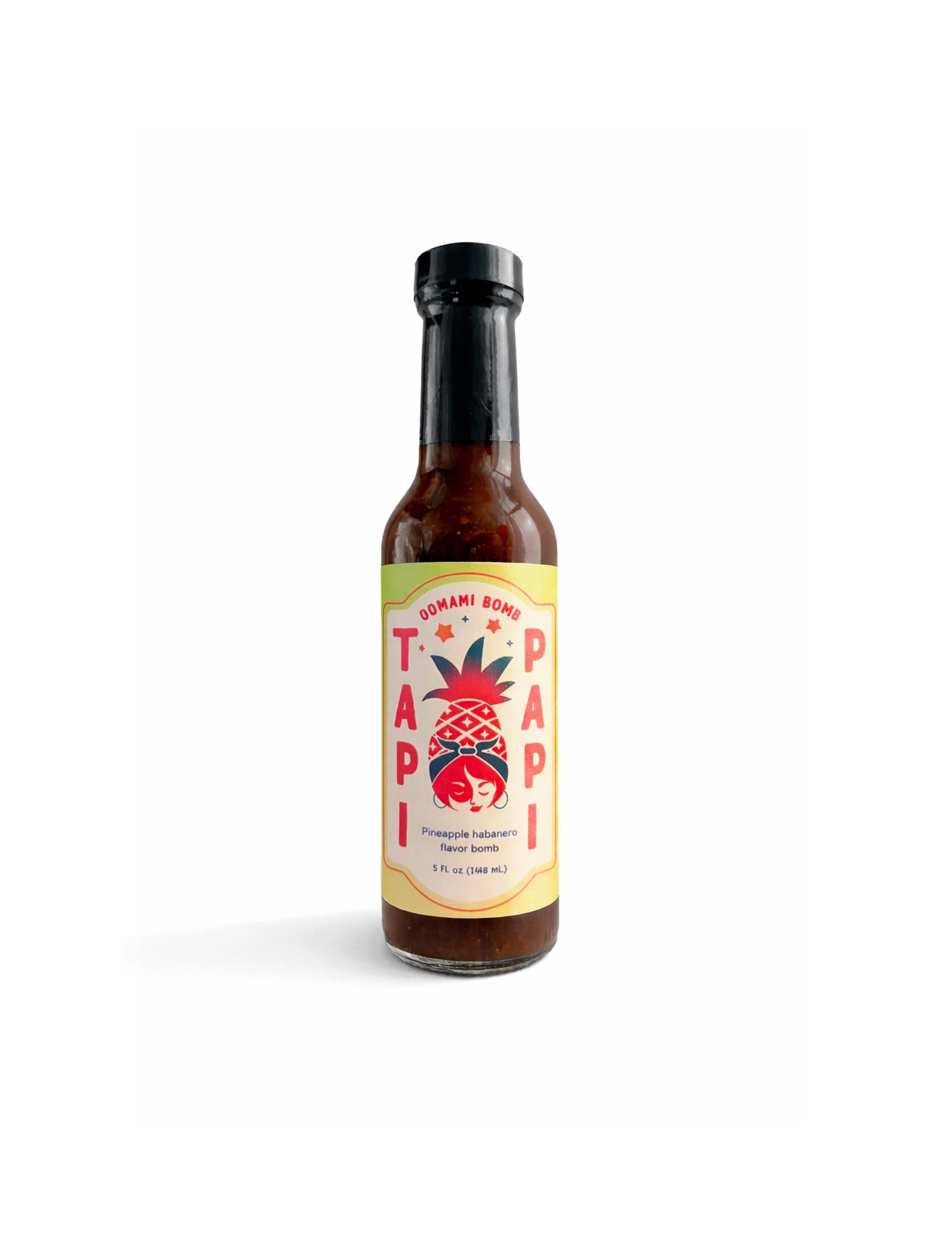 Front view of a Tapi Papi Umami Bomb hot sauce bottle.