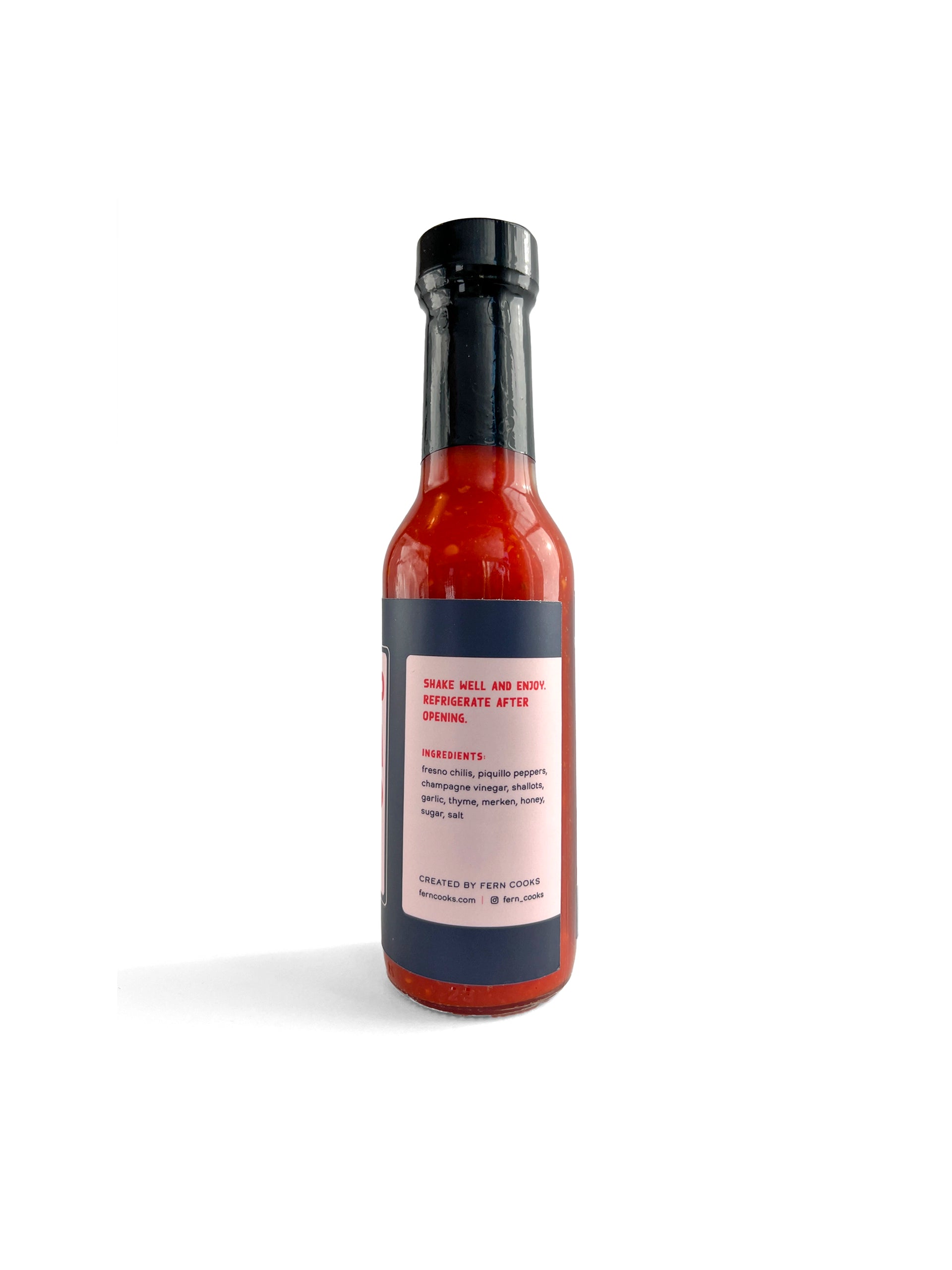 Back view of a Tapi Papi chili honey hot sauce bottle.